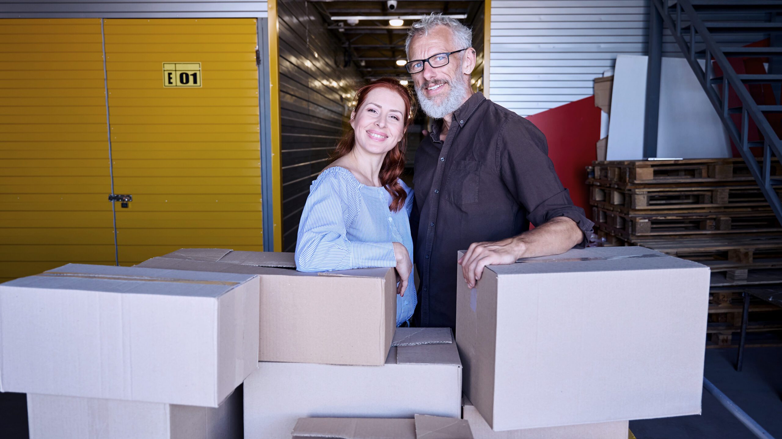 Small business owners in Birmingham warehouse preparing parcels for same-day delivery