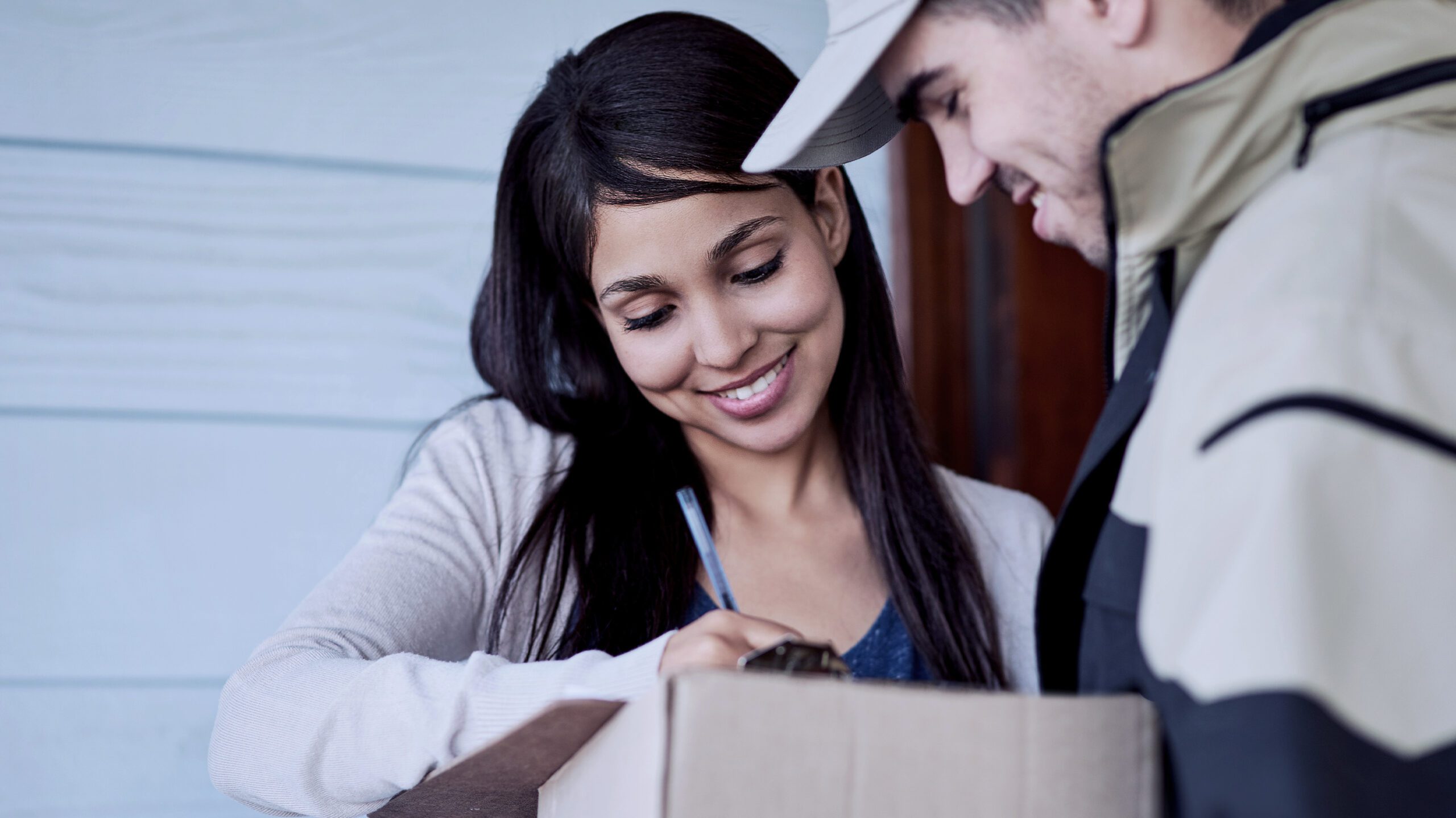 Customer signing for parcel delivered by courier in Birmingham