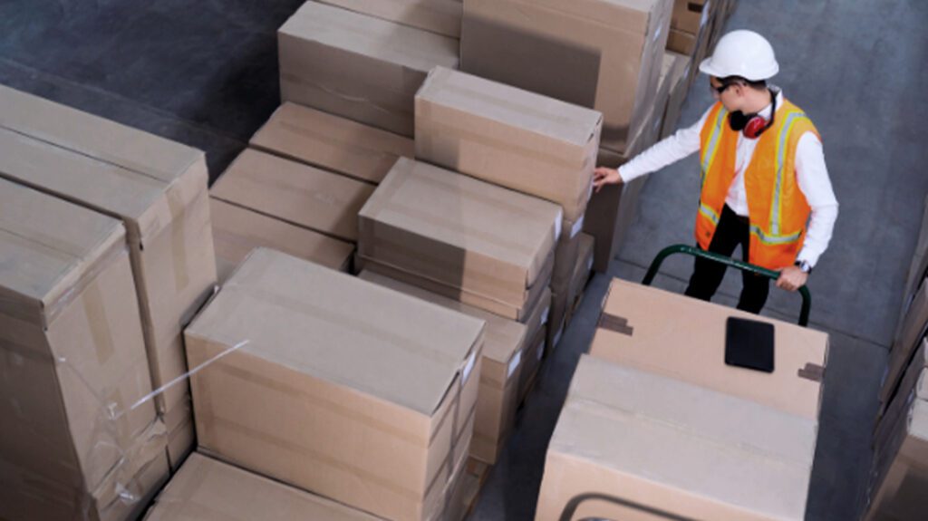 Warehouse worker inspecting packages for courier dispatch