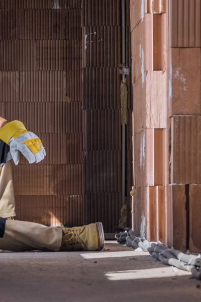 Construction worker resting at building site after material delivery